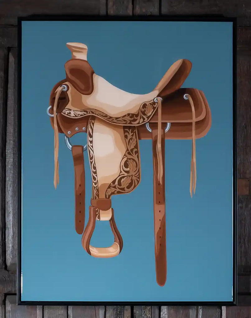 Horse Saddle Framed Art, showcasing a realistic depiction of a western saddle against a tranquil sky blue backdrop, encased in a matte black wood frame.