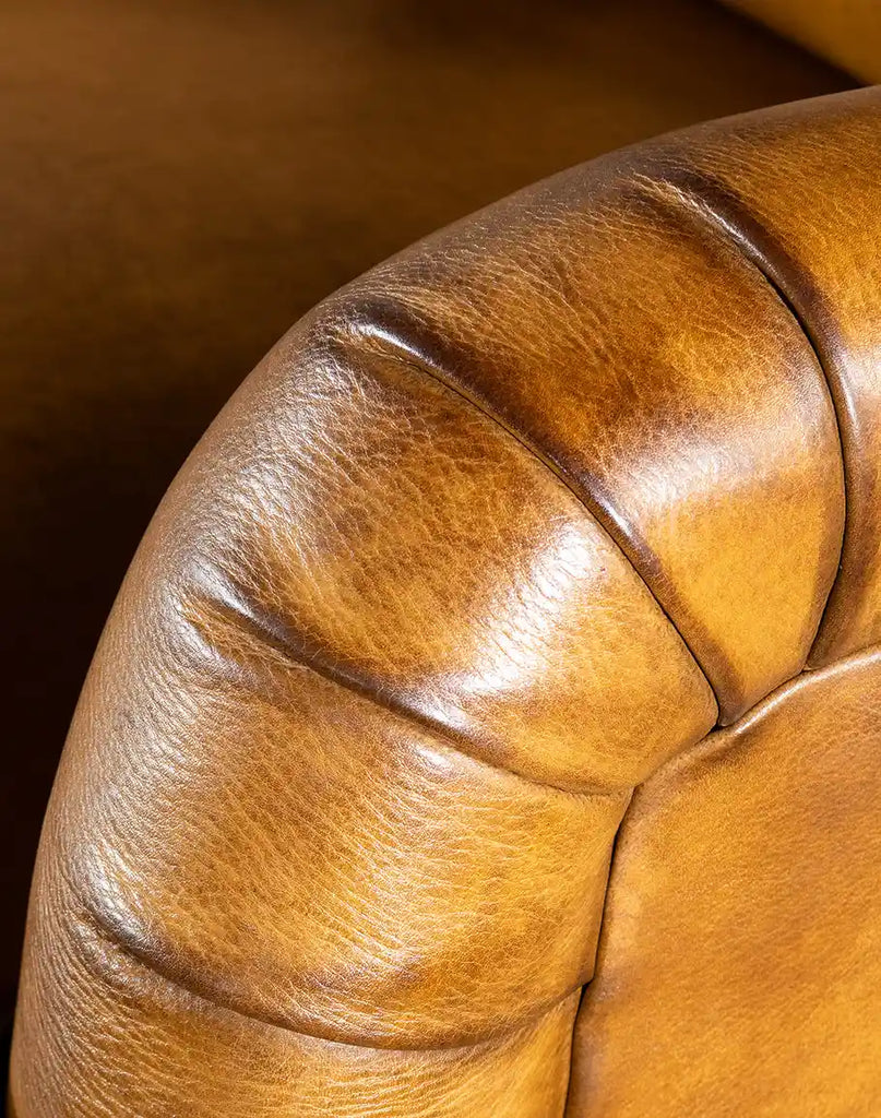 Close-up of the hand-burnished leather on the Hulton Swivel Glide Chair, highlighting its rich texture and superior craftsmanship.