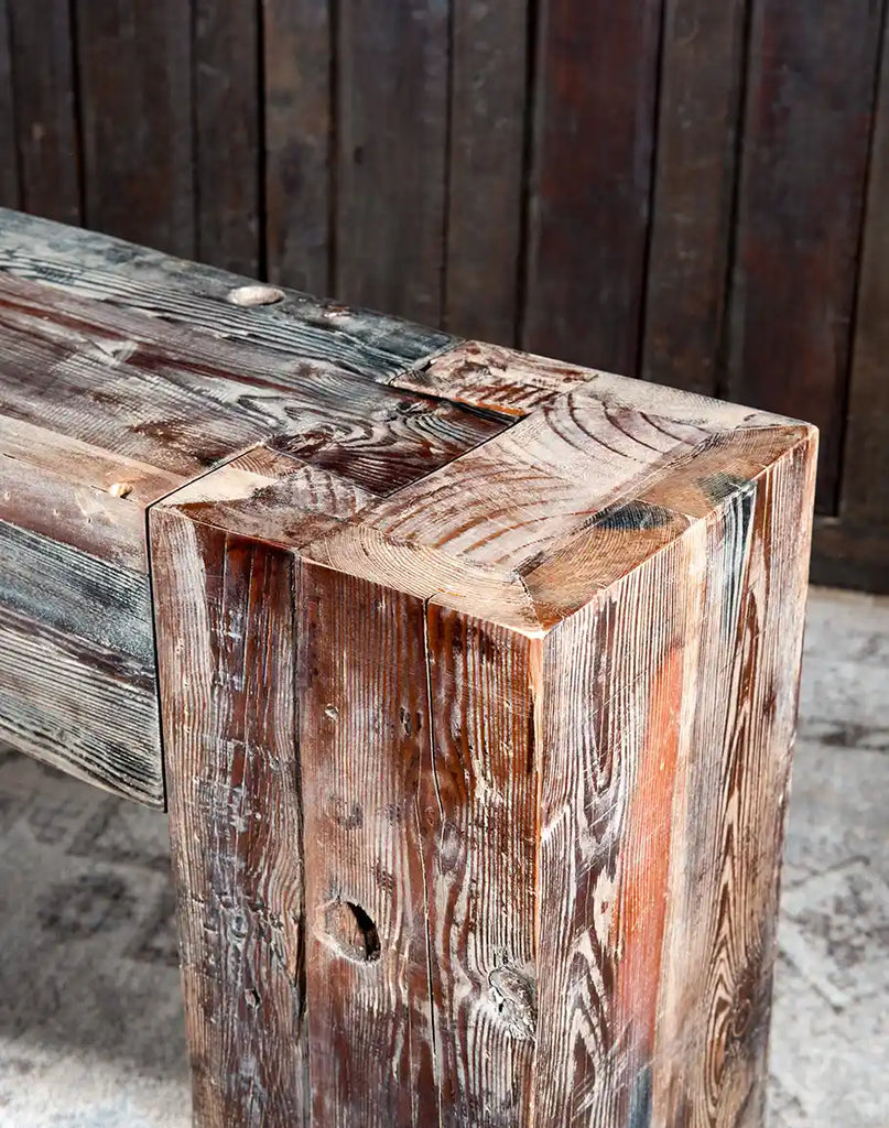 The Ivanna Sofa Table highlighting the distinct color and texture variations of the reclaimed boat wood.