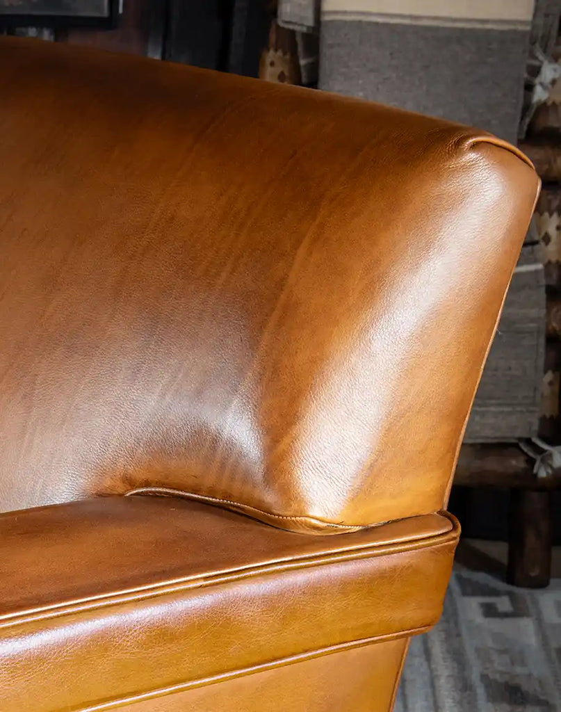 Detailed view of the hand-burnished finish on the Jaxon Leather Chair, highlighting its craftsmanship.