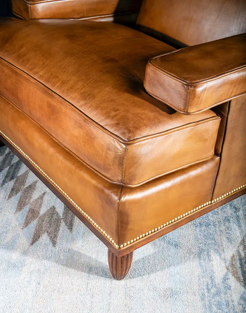 Close-up view of the sturdy, hand-finished legs of the Jaxon Leather Chair, showcasing their craftsmanship and durability.