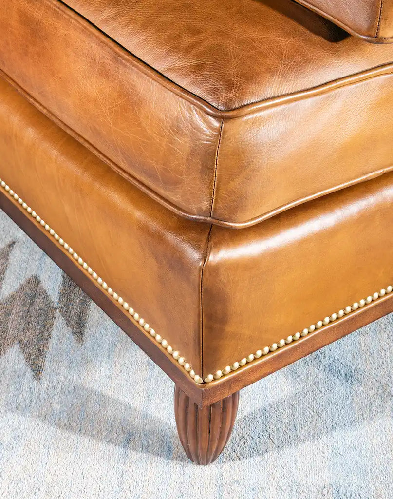 Detailed view of the gold-colored nail tacks on the Jaxon Leather Chair, adding an elegant rustic touch.