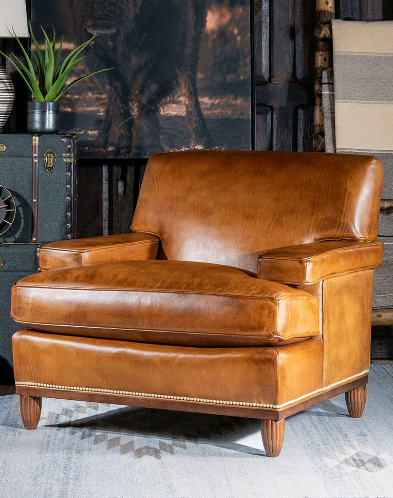 Front view of the Jaxon Leather Chair showcasing its premium full-grain leather and gold-colored nail tacks.