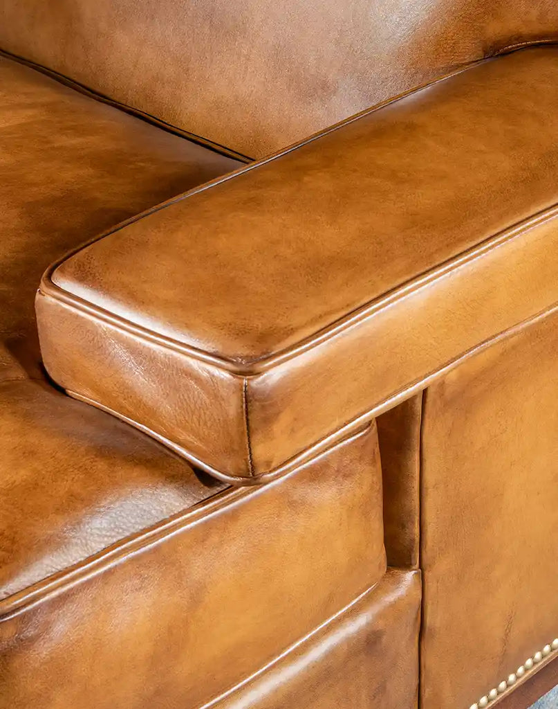 Close-up of the Jaxon Leather Sofa's armrest featuring meticulous craftsmanship and luxurious leather.