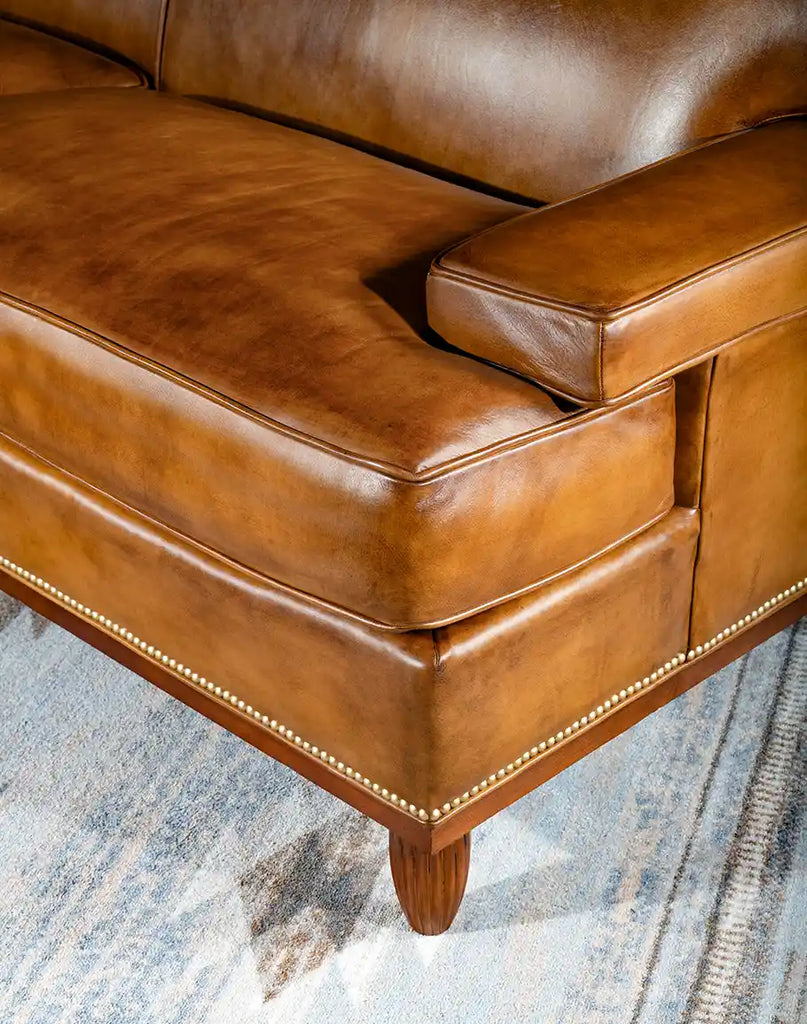 Detailed view of the base and legs of the Jaxon Leather Sofa highlighting the durable construction and attention to detail.