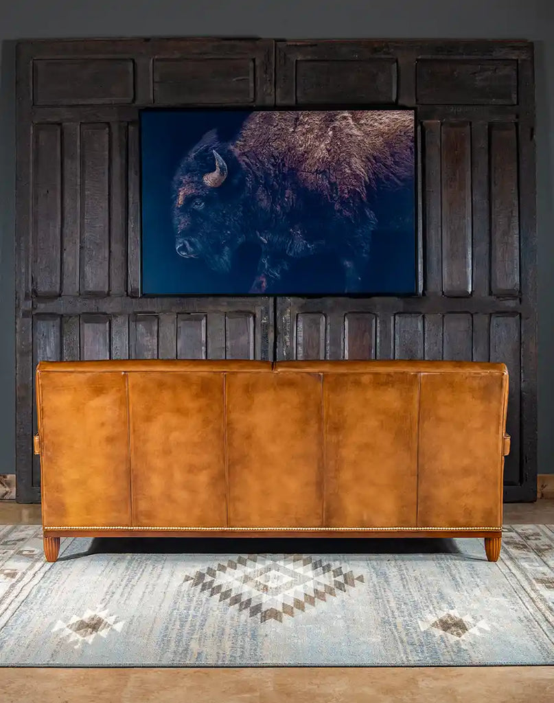 Rear view of the Jaxon Leather Sofa displaying the tight seat back and gold-colored nail tacks.