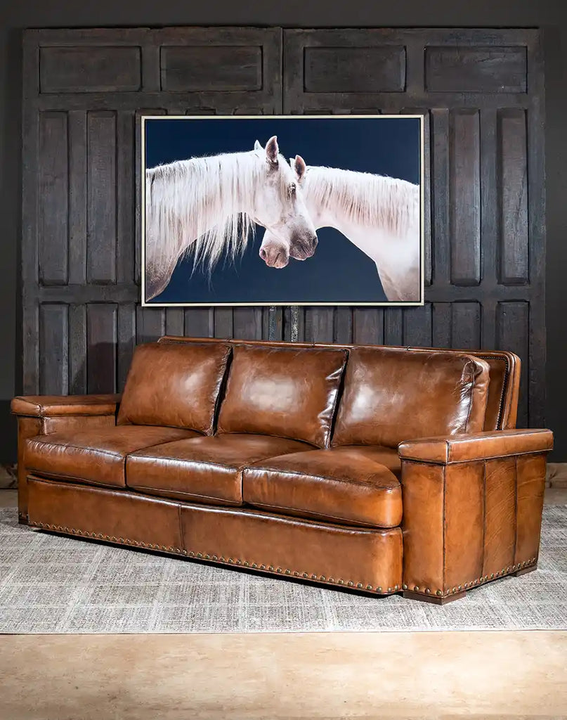 Angled view of the Jefferson Leather Sofa, emphasizing its generous size and luxurious design.