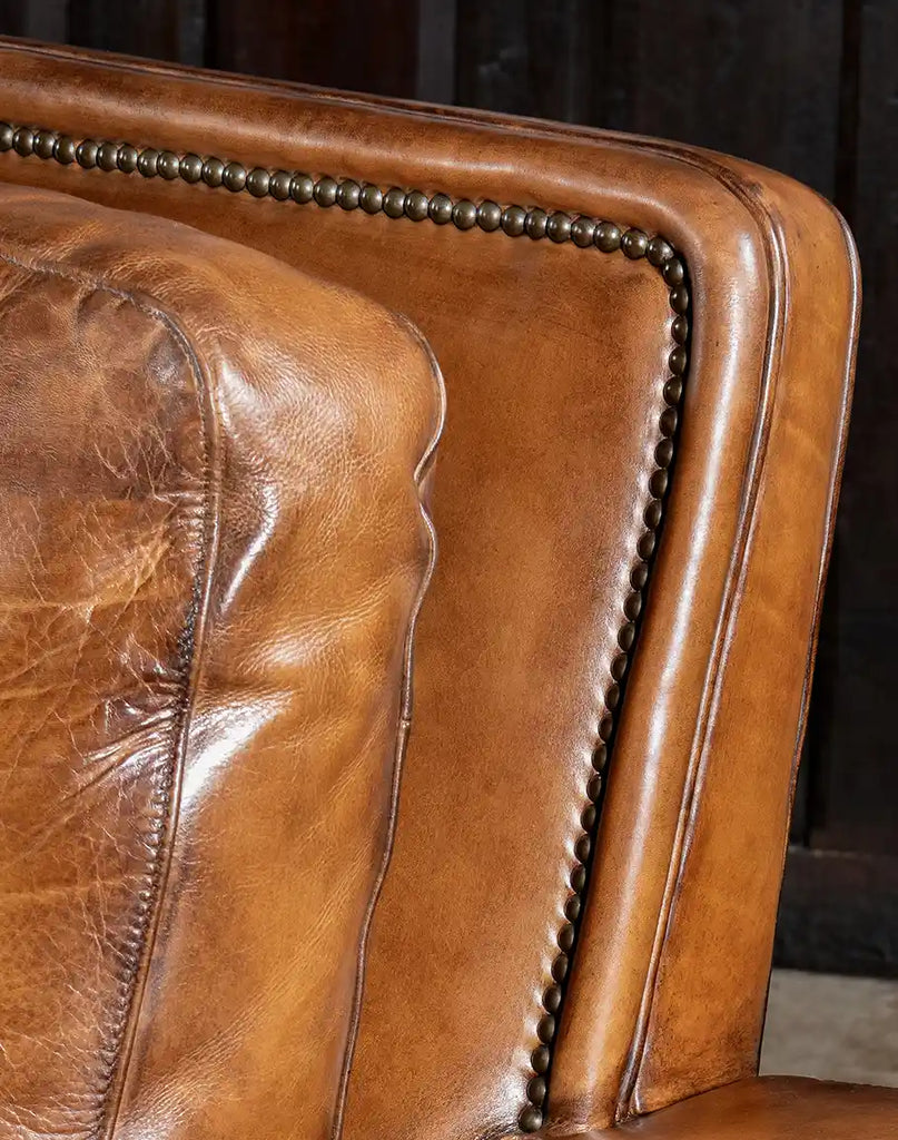 Close-up image of the brass nail tacks adorning the Jefferson Leather Sofa.