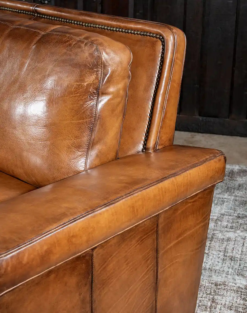 Detailed shot focusing on the hand-burnished leather craftsmanship of the Jefferson Leather Sofa.