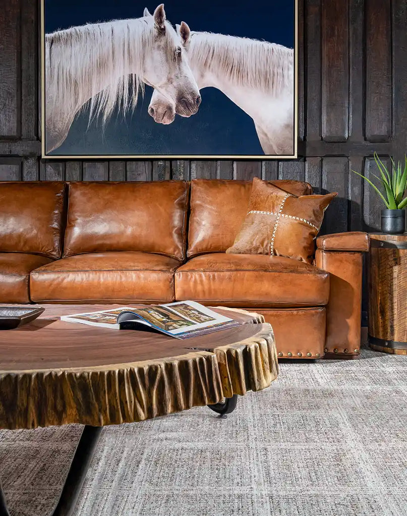 The Jefferson Leather Sofa placed in a modern rustic living room environment, illustrating its aesthetic appeal.