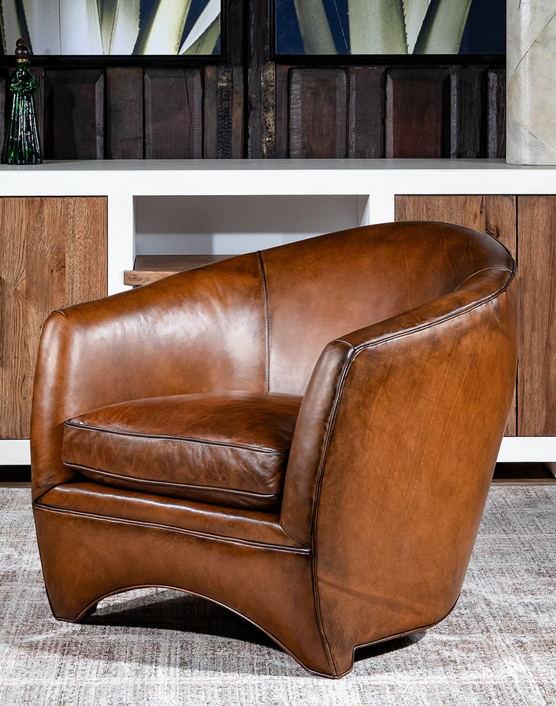 Johnson Leather Chair showcasing its sleek curved design and hand-burnished full-grain leather.