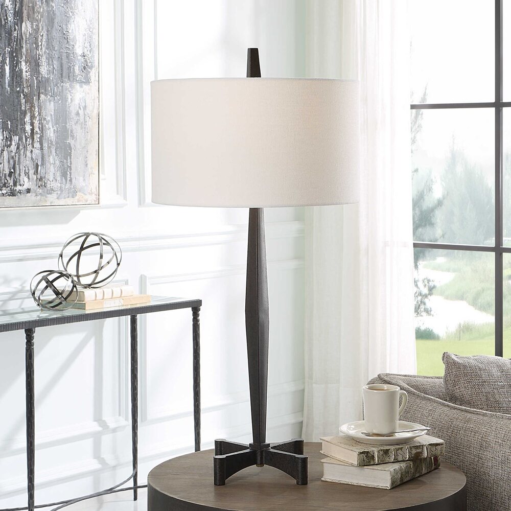 Katana Table Lamp featuring a tapered black metal base with aged finish and industrial-style foot design.