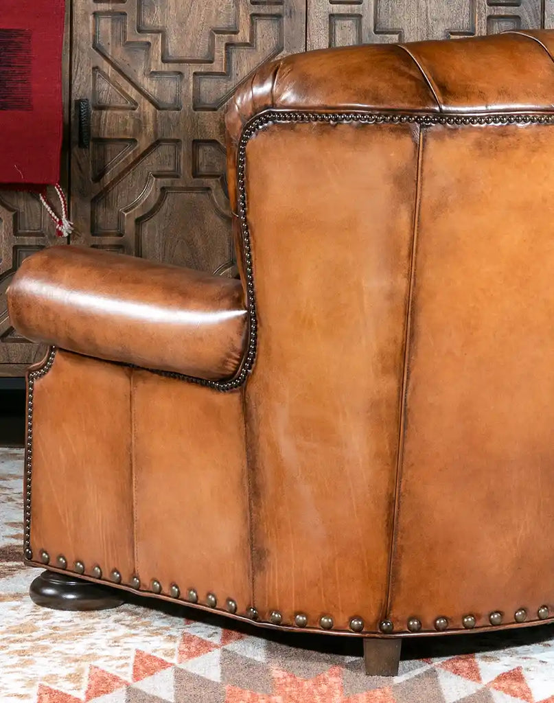 A side profile of the King Arthur Tufted Chair highlighting its 8-way hand-tied construction and elegant silhouette.