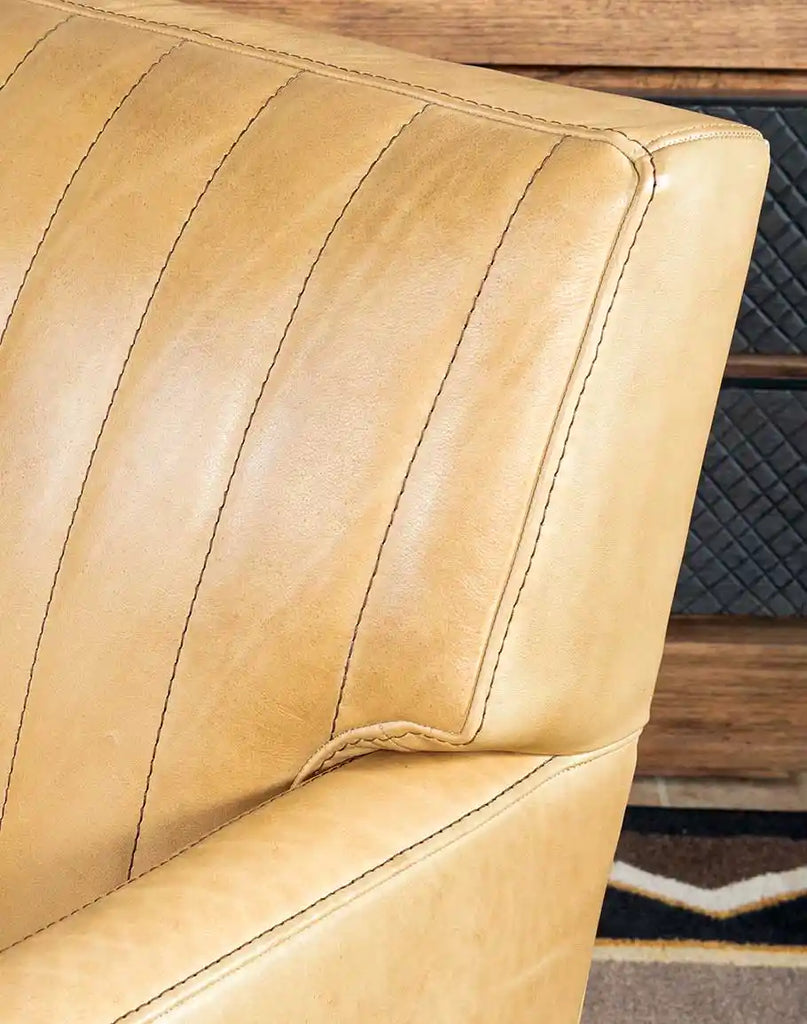 Detailed shot focusing on the stitched channeling pattern on the inside back of the Kobi Sand Swivel Chair.