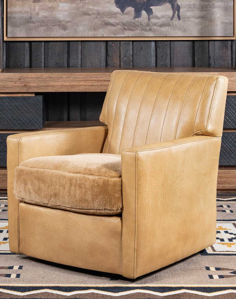 Kobi Sand Swivel Chair showcasing its full-grain Palomino leather upholstery and shearling seat cushion.