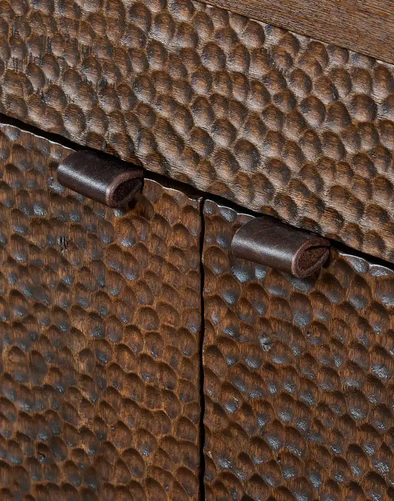 Detailed close-up of the hand-chiseled texture on the buffet's front panels, highlighting the artisanal craftsmanship and two-tone stained effect.