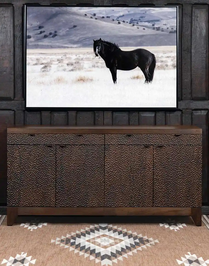 View of the hammered copper-like effect created by the two-tone stain on the hand-chiseled panels of the buffet's front.