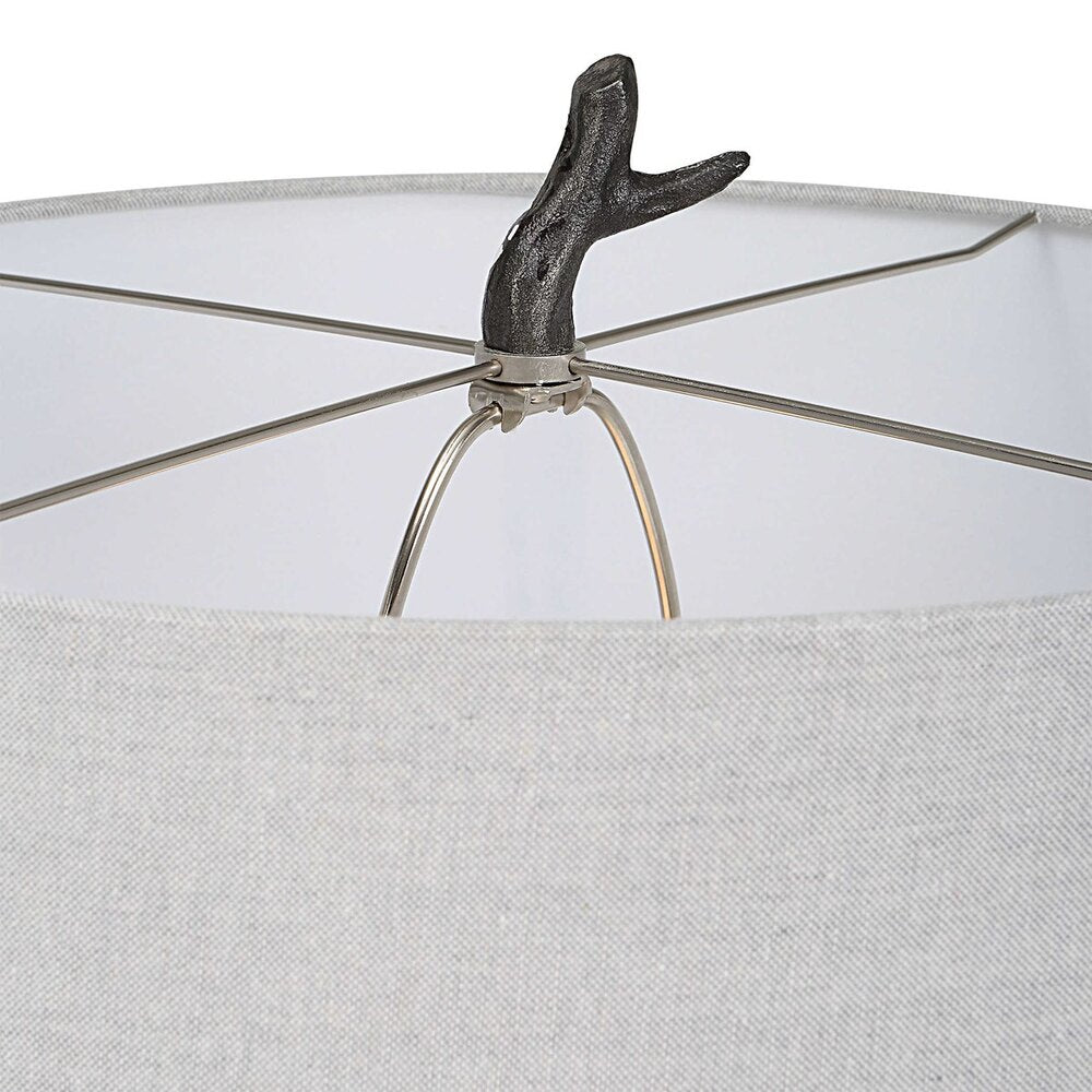 Distressed black floor lamp with subtle silver accents, a tree branch-style base, and a light gray hardback drum shade.