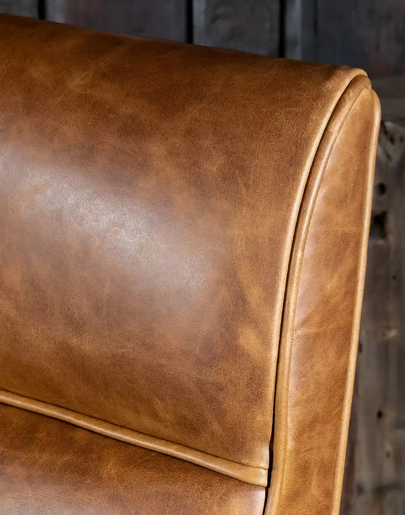 Close-up of the hand-burnished leather upholstery on the Liyanna Leather Recliner, showcasing its rich texture and patina.