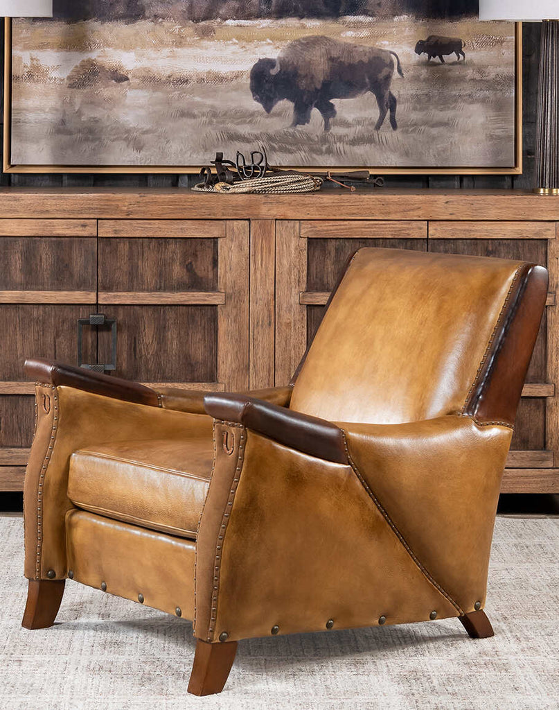 A stylish Lucy Leather Chair featuring full-grain leather and brass nail detailing.