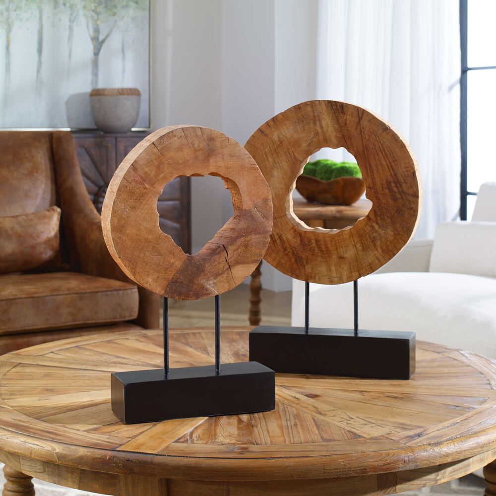 Decorative mango wood logs with a natural texture and minimalist black metal stands.