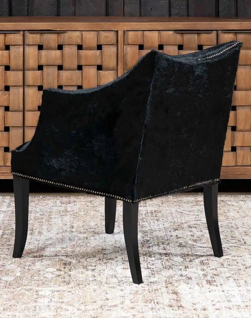 A rear view of the McClaren Midnight Cowhide Chair, highlighting the natural cowhide panel and hand-finished leather.