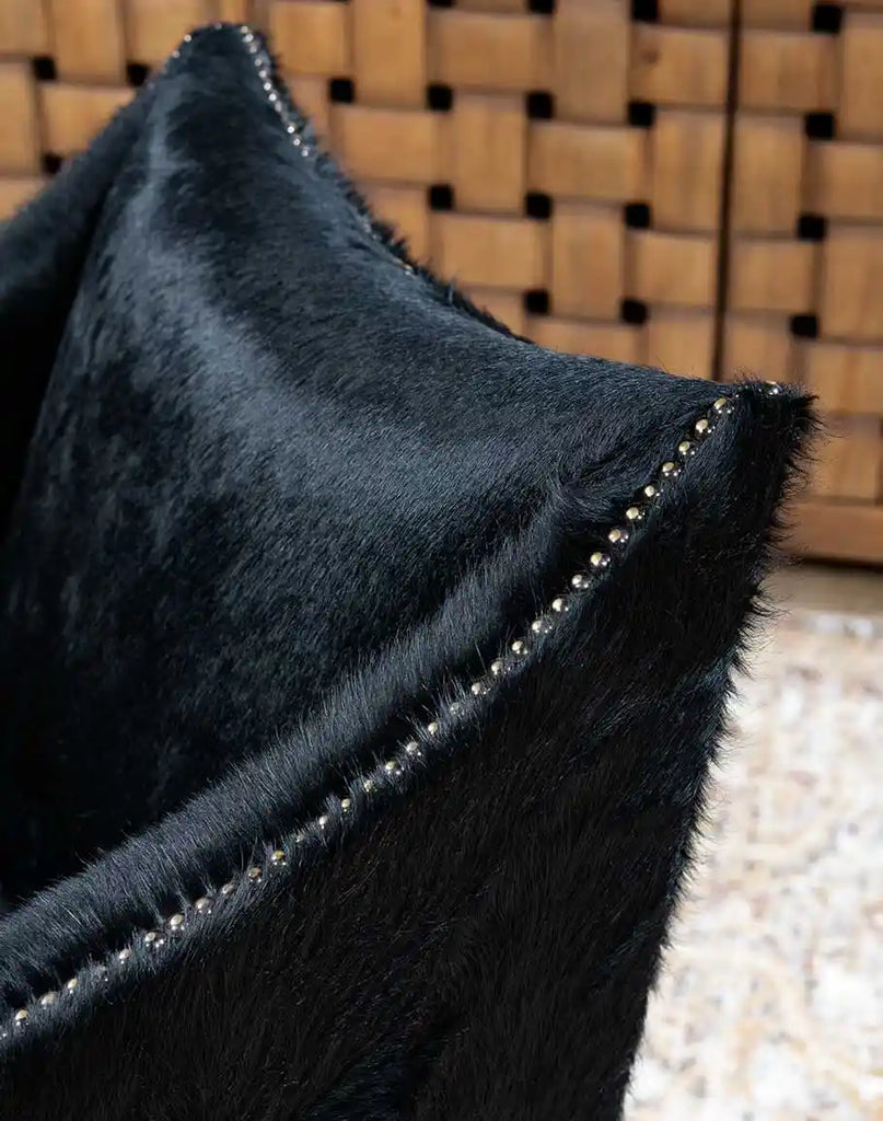 A detailed close-up of the authentic cowhide accents on the McClaren Midnight Cowhide Chair, showing the unique texture and patterns.