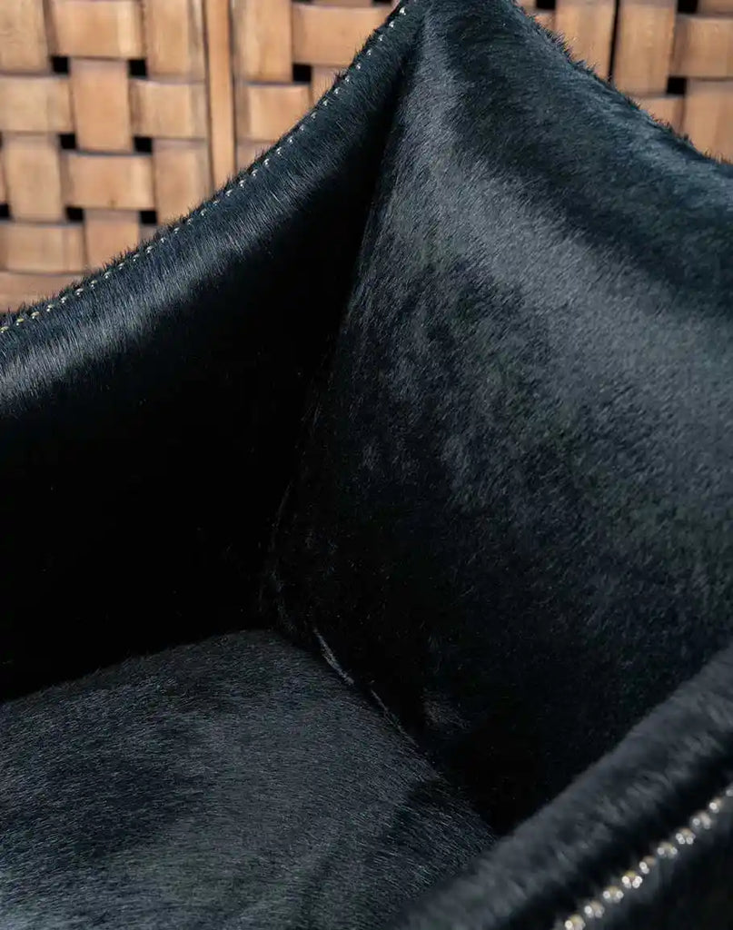 A zoomed-in view of the thick seat cushion on the McClaren Midnight Cowhide Chair, designed for supreme comfort and support.