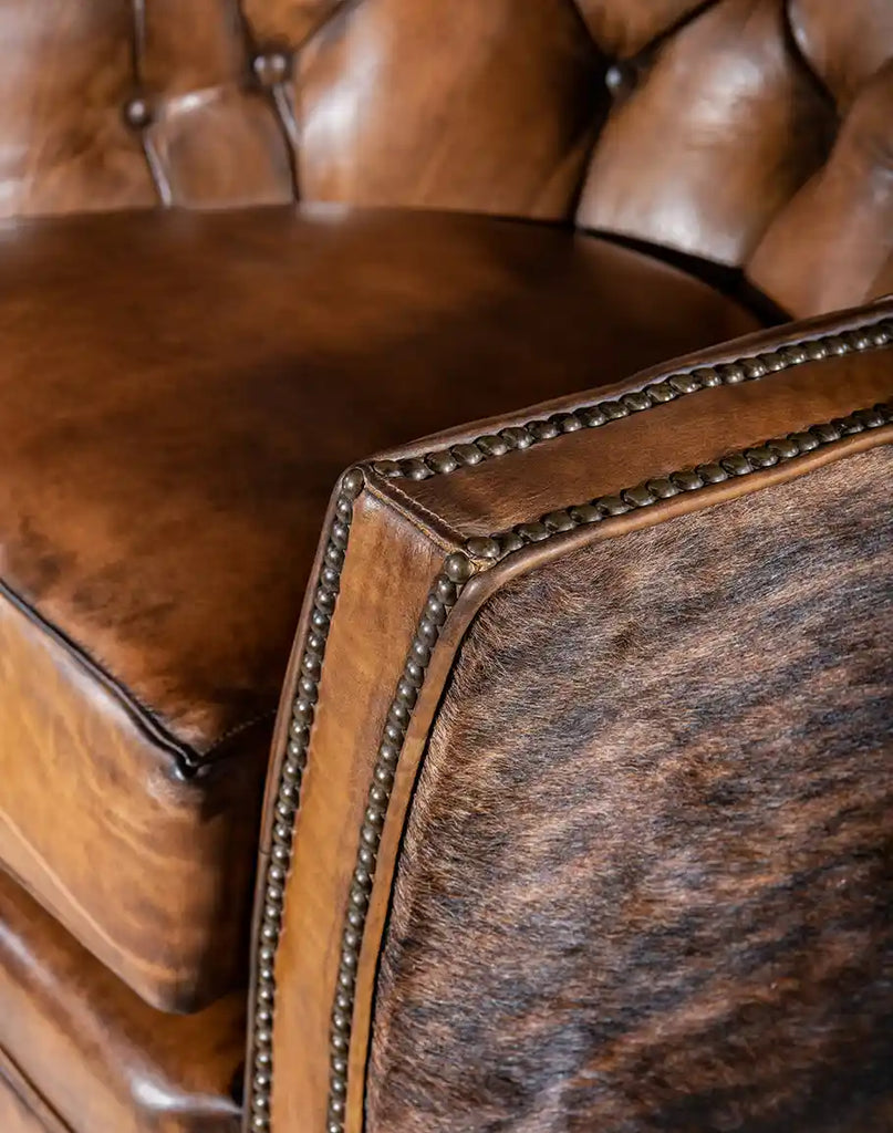 Detailed view of the armrest on the Medina Brindle Swivel Glider, crafted with premium full-grain leather for ultimate comfort.