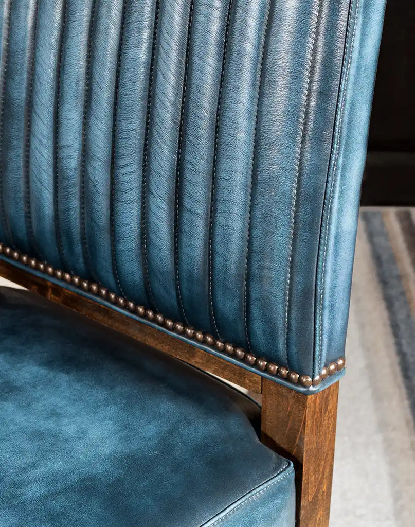 Detailed close-up of the blue top-grain leather upholstery, emphasizing its texture and hand-antiqued finish.