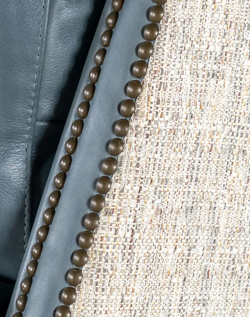 Detailed shot of the brass nail tack trim, adding a sophisticated and refined touch to the recliner’s design.