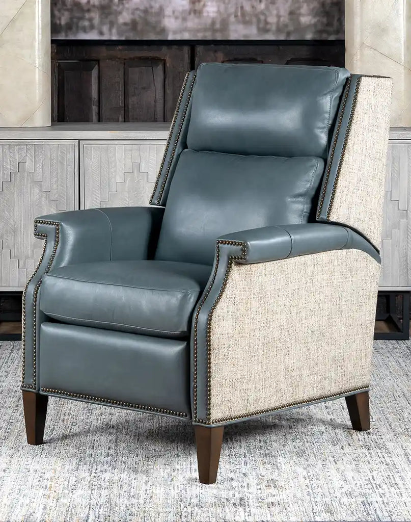 An angled full front view of the Miley Grey Leather Recliner, showcasing its premium leather upholstery and classic bustle-back design.