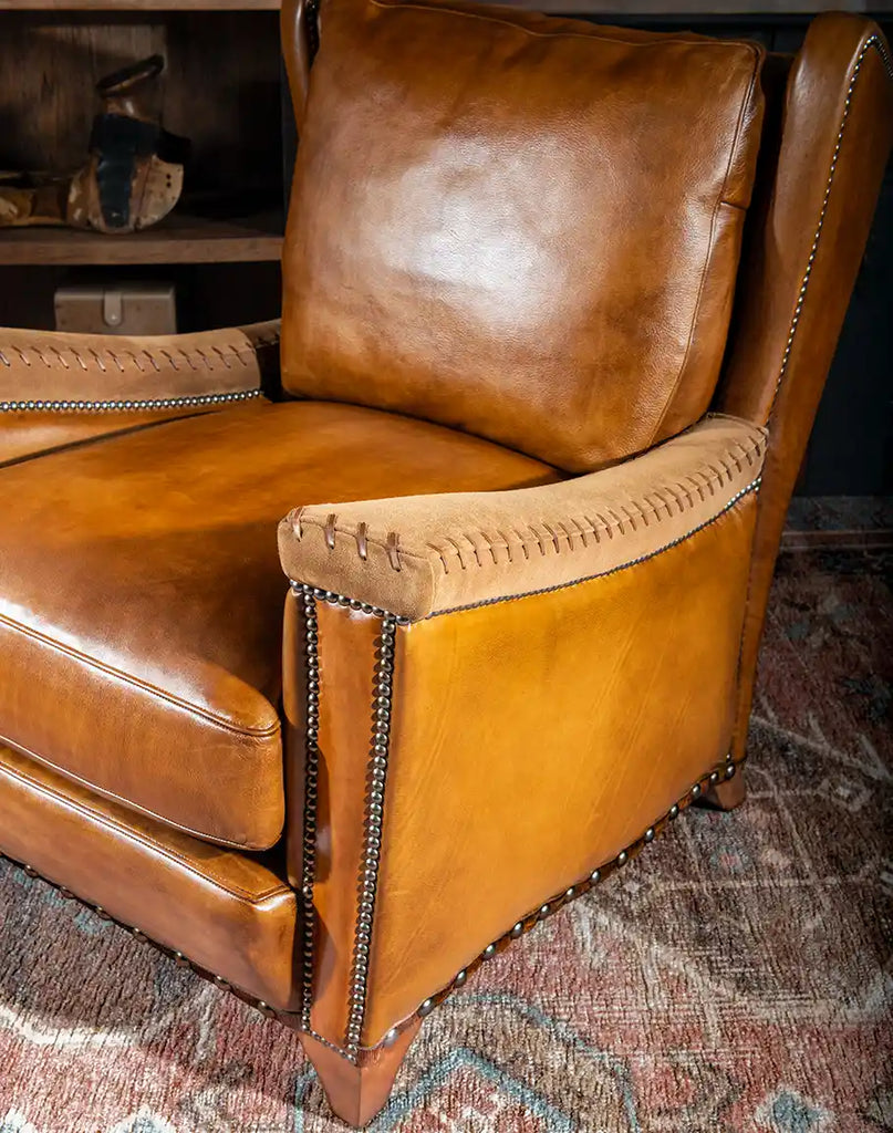 Close-up of the Norseman Leather Chair's padded armrests, featuring clean and simple lines for a modern aesthetic.