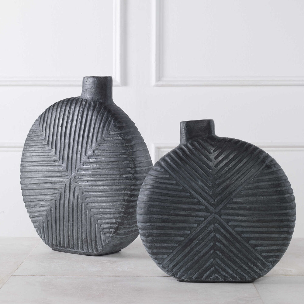 Aged black vases in small and large sizes, featuring contemporary geometric designs and versatile use for flowers or decor accents.