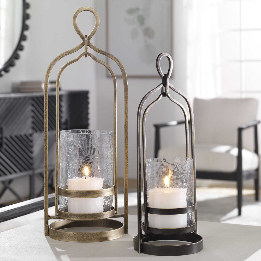 Stylish dark bronze Moroccan candleholder with gold rub-through details and a glass hurricane, perfect for ambient lighting.