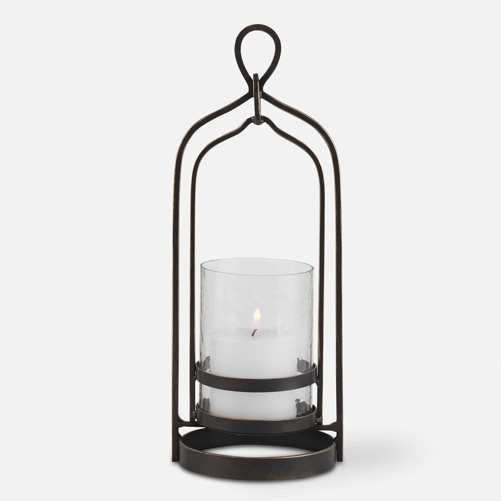 Moroccan-inspired bronze candleholder with gold rub-through accents and textured glass hurricane, featuring a white 3"x3" candle.