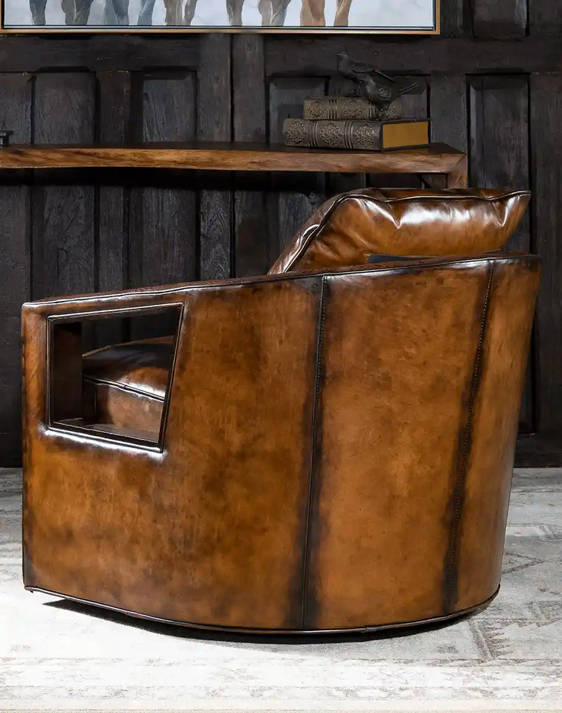 Side profile of the Morocco Swivel Chair, emphasizing its sturdy hardwood frame and seamless leather craftsmanship.