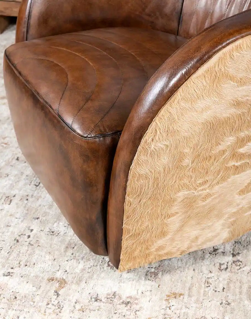 A detailed shot of the bottom frame and hidden swivel mechanism on the Moscow Mocha Swivel Chair, ensuring durability.