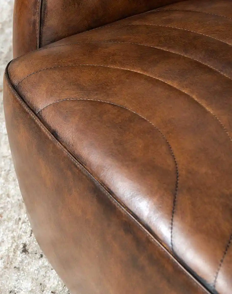 A close-up of the hand-stitched seams on the Moscow Mocha Swivel Chair, showcasing expert craftsmanship.