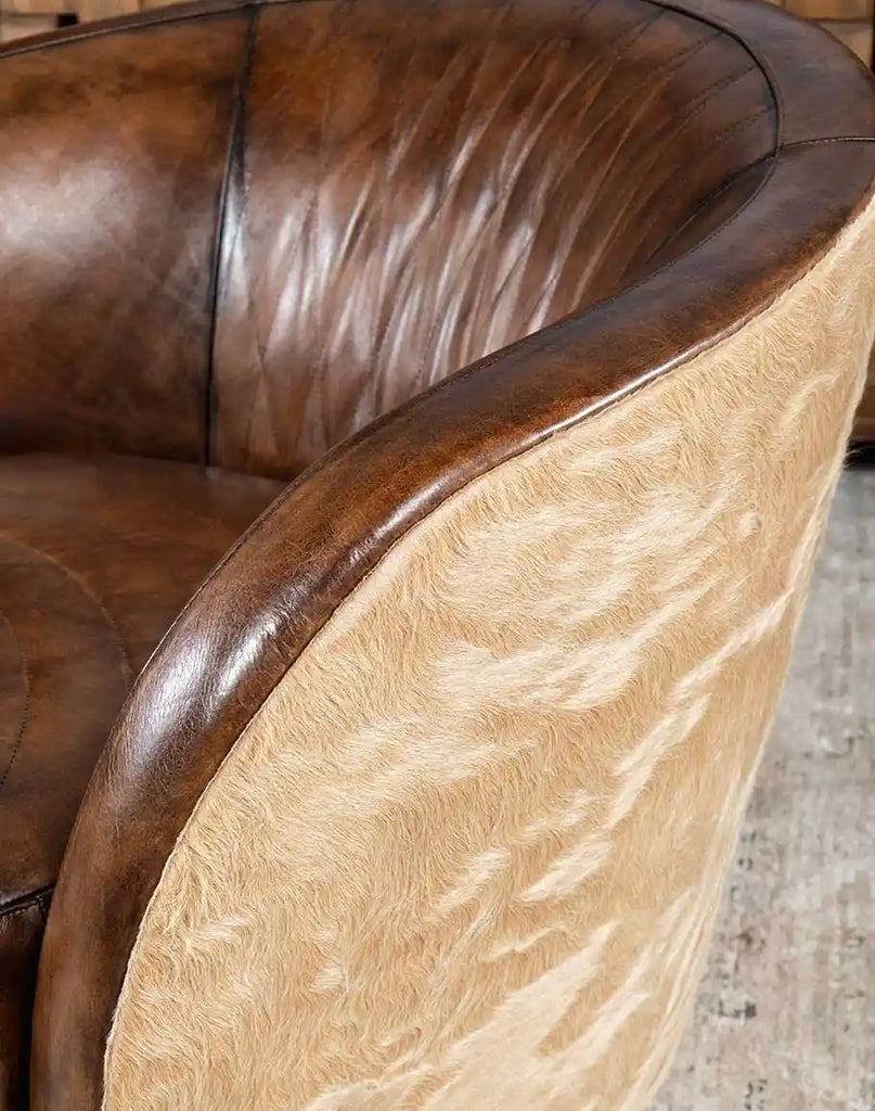 A texture-focused close-up of the mocha leather on the Moscow Mocha Swivel Chair, emphasizing its soft and luxurious feel.