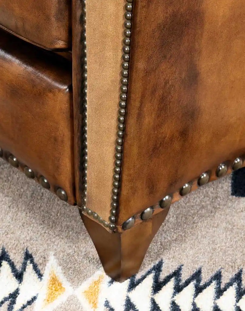 Front wooden base of the Vlad Brown Leather Recliner, designed for durability.