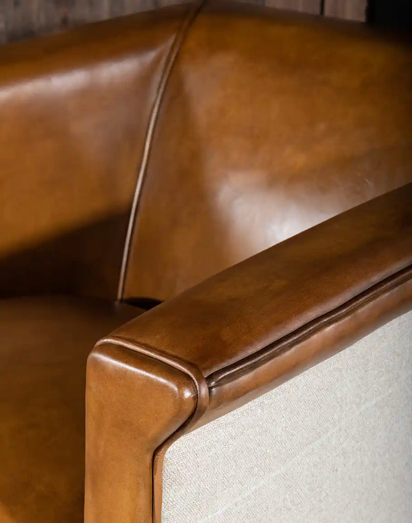 Detailed view of the Napoleon Club Chair's armrest, showcasing the craftsmanship and quality of the leather and stitching.