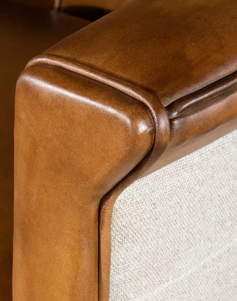 Close-up image focusing on the hand-burnished details of the full-grain leather upholstery on the Napoleon Club Chair.