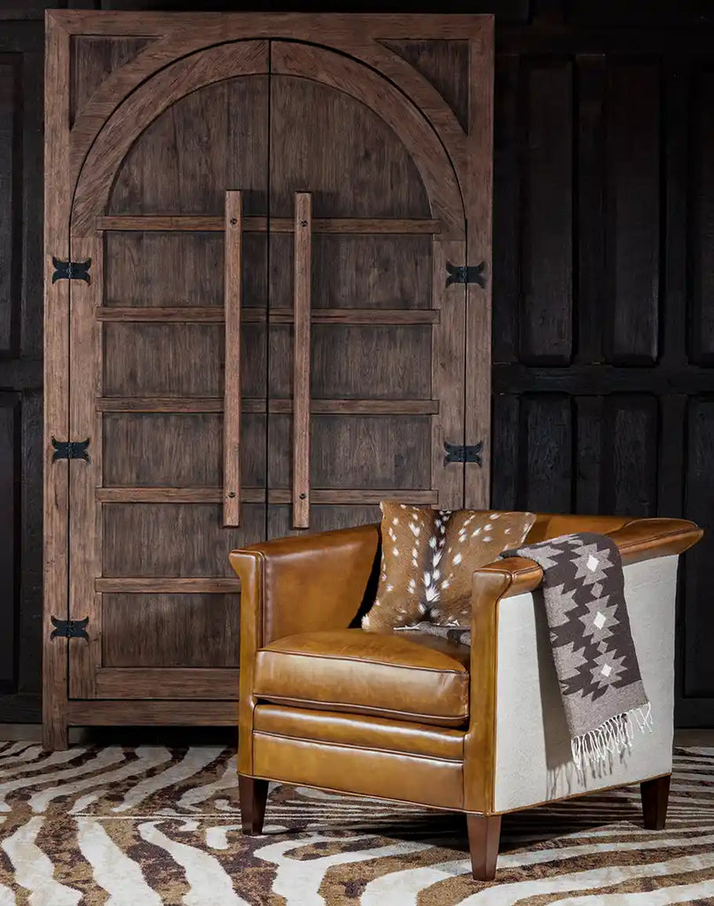 The Napoleon Club Chair placed in a living room setting, demonstrating its blend of rustic elegance and modern style.