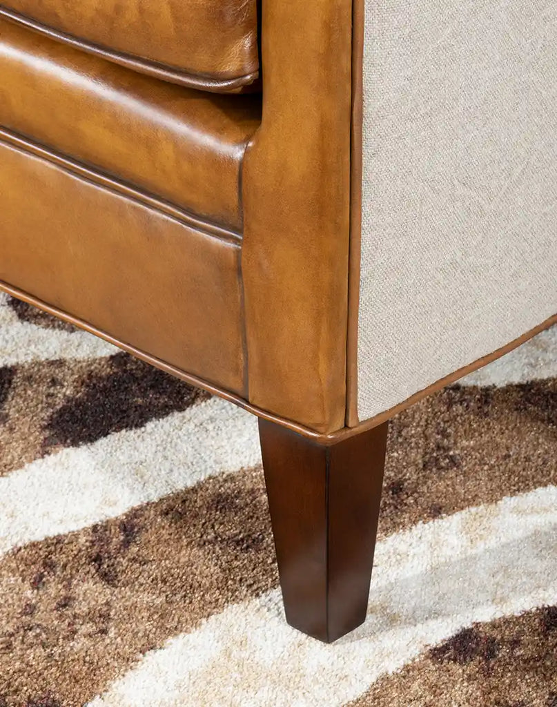 Close-up of the Napoleon Club Chair's leg design, illustrating the sturdy construction and attention to detail.