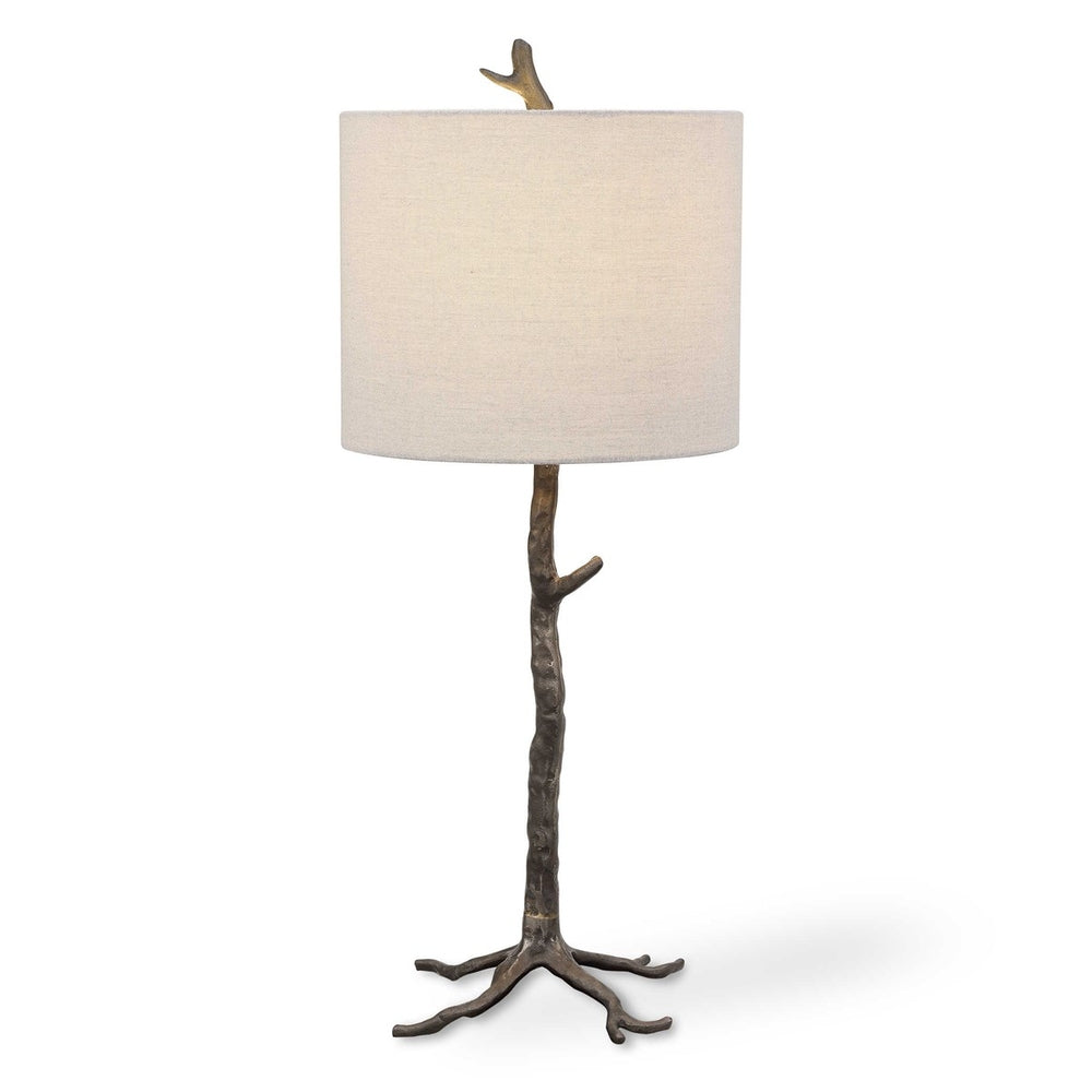 Nature-inspired table lamp with a sleek gunmetal base, gold embellishments, and a slubbed linen drum shade.