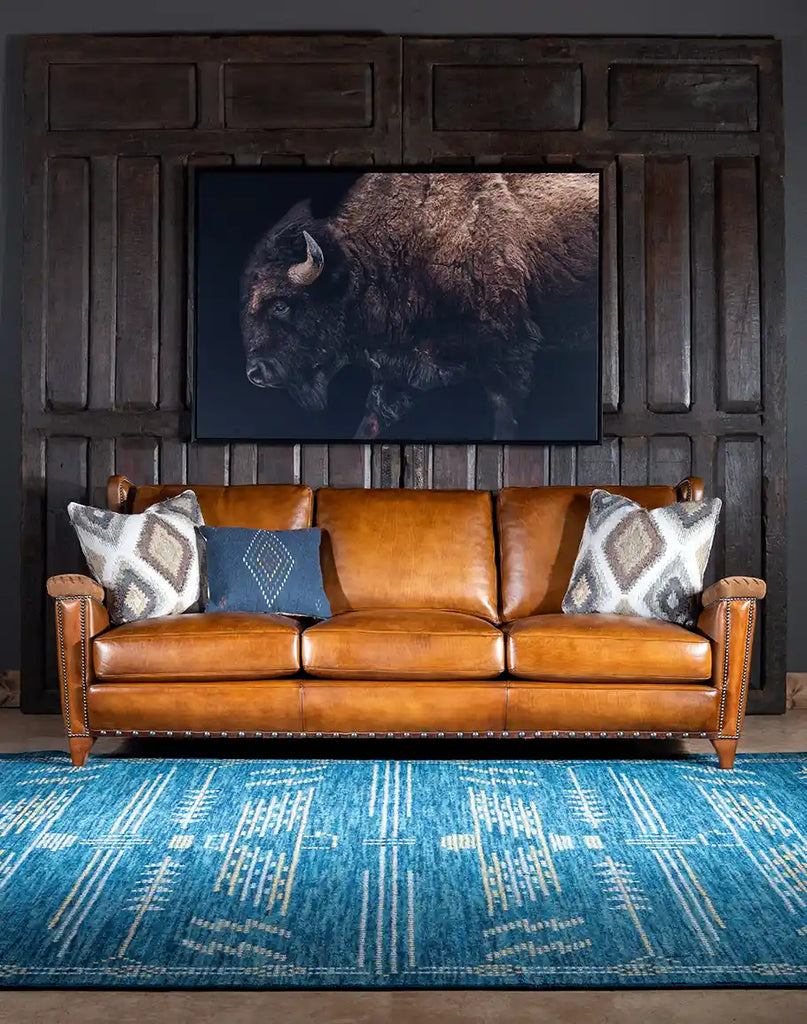 The Norse Leather Sofa placed in a rustic ranch-style living room, blending seamlessly with natural decor elements.