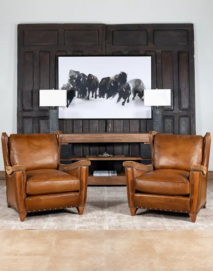 The Norseman Leather Chair styled in a rustic living room setting, blending timeless elegance with a warm ambiance.