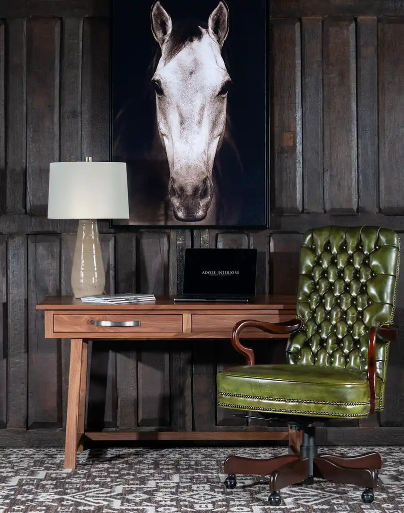 The Norton Olive Executive Desk Chair styled in a rustic office setting, blending luxury and practicality.