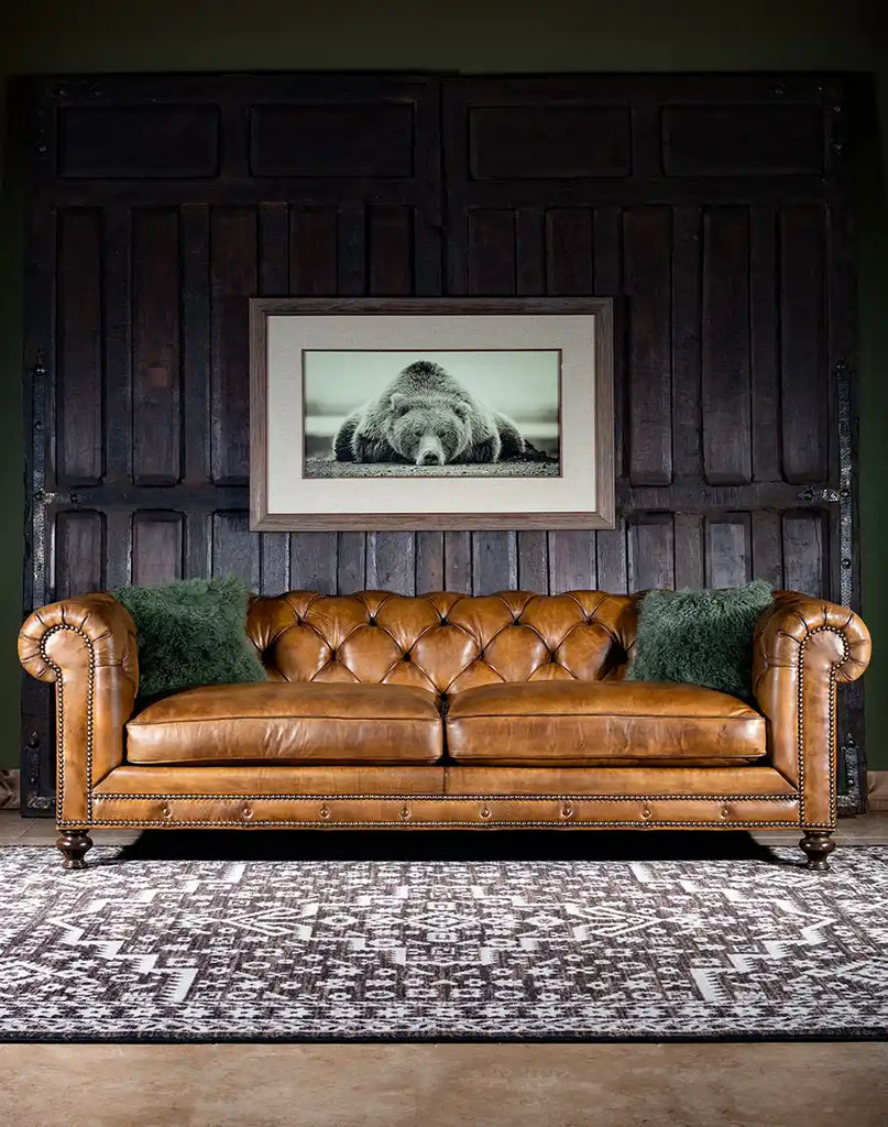 Nova Chesterfield Sofa upholstered in hand-burnished leather and accented with brass nail heads and deep tufting, this sofa showcases impeccable craftsmanship and attention to detail.